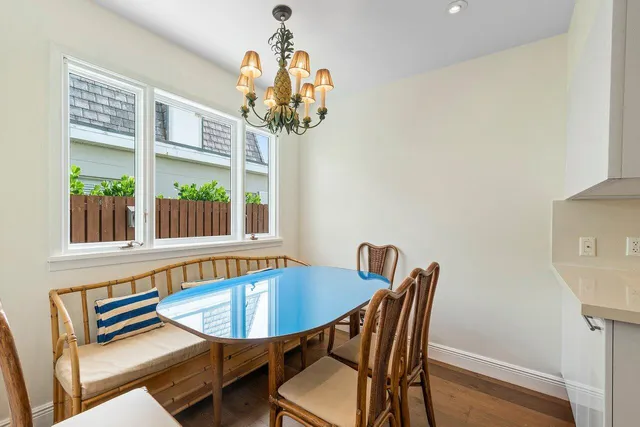 a view of a dining room with furniture wooden floor and chandelier