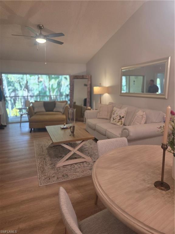 3531 County Barn Road, Unit C201 Naples, FL 34112 - Photo 11 of 20 Living area with lofted ceiling, wood finished floors, and a ceiling fan