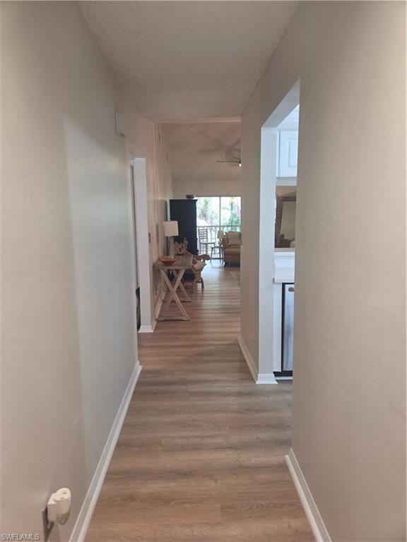 3531 County Barn Road, Unit C201 Naples, FL 34112 - Photo 2 of 20 Entry way Corridor with light wood-type flooring and baseboards
