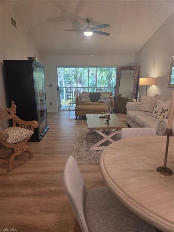3531 County Barn Road, Unit C201 Naples, FL 34112 - Photo 3 of 20 Living area featuring vaulted ceiling, light wood-type flooring, and a ceiling fan