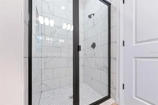 a bathroom with a glass shower door