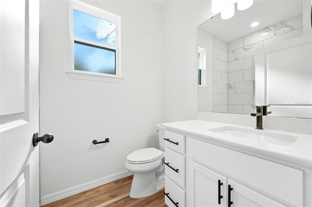 115 Leon Street Altamonte Springs, FL 32701 - Photo 15 of 15 a bathroom with a sink a toilet and a mirror
