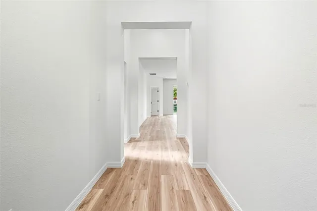 a view of a bedroom with wooden floor