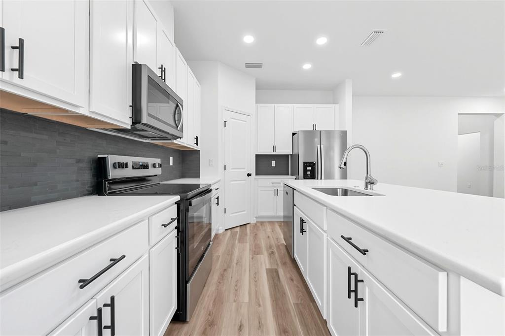 115 Leon Street Altamonte Springs, FL 32701 - Photo 4 of 15 a kitchen with stainless steel appliances sink stove and microwave