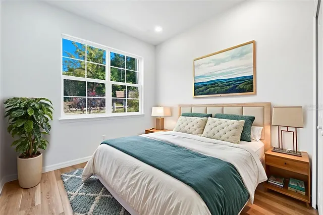 a bedroom with a bed and a large window