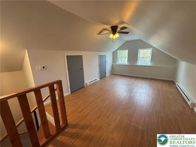 a view of an entryway wooden floor and a ceiling fan
