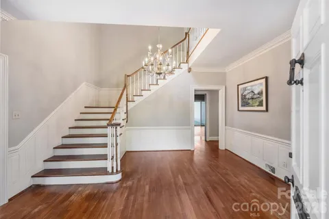 a view of entryway and hall with wooden floor