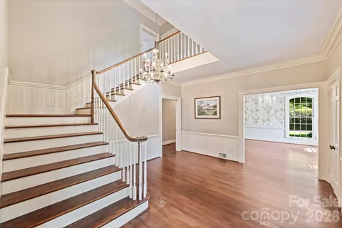 a view of entryway and hall with wooden floor