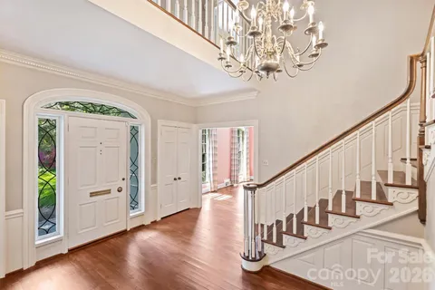a view of entryway with wooden floor and stairs