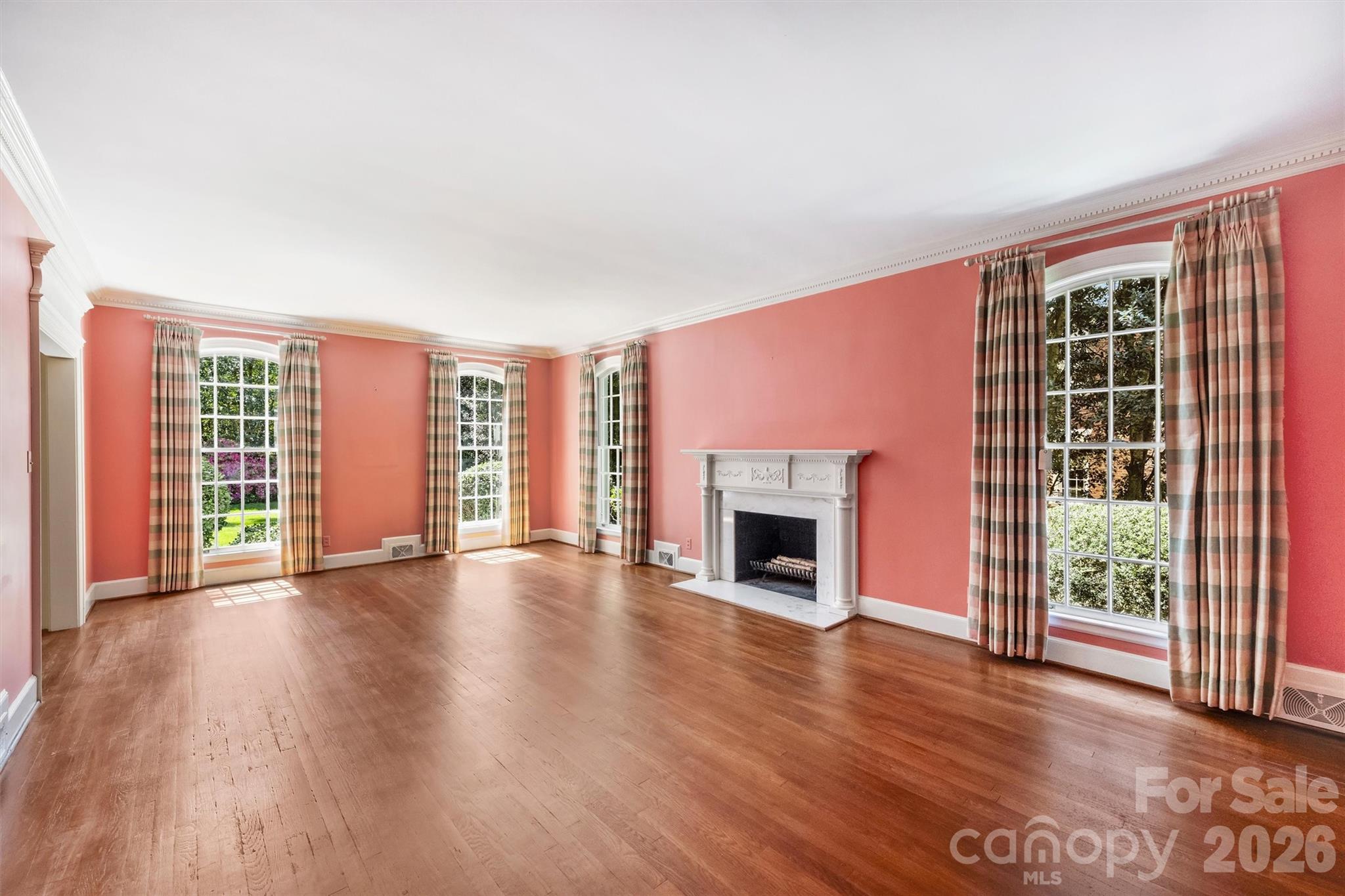 812 Ardsley Road Charlotte, NC 28207 - Photo 16 of 44 a view of empty room with wooden floor and fireplace