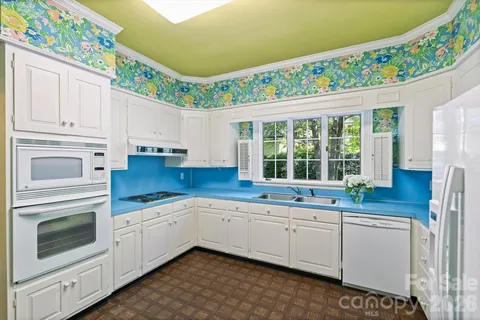 a kitchen with a sink stove and cabinets