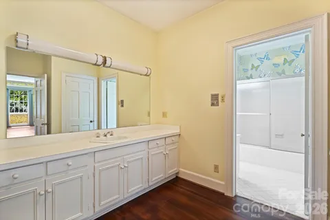 a spacious bathroom with a double vanity sink and a mirror