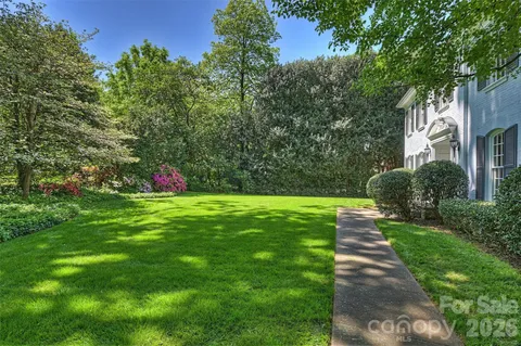 a view of a garden with flowers and trees