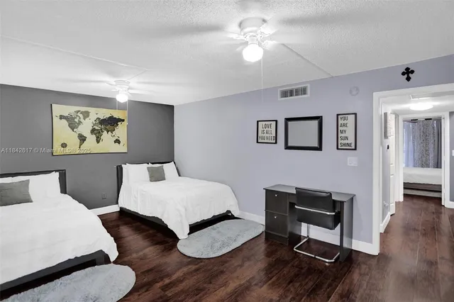 a bedroom with a bed chandelier and a window