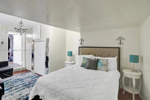 a bedroom with a bed mirror and a window