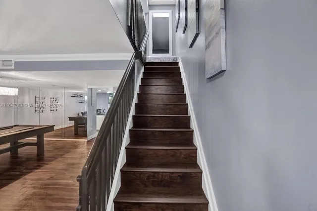 a view of entryway and hall with wooden floor