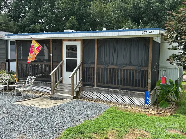 a view of backyard with a slide and a bench
