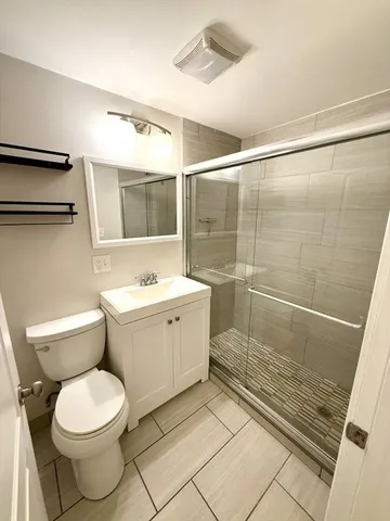 a bathroom with a toilet sink and shower