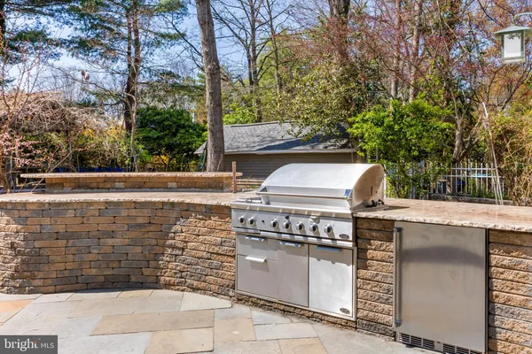 a view of a patio with table and chairs and a stove