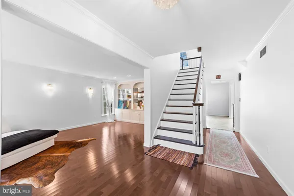 a view of a room with stairs and wooden floor