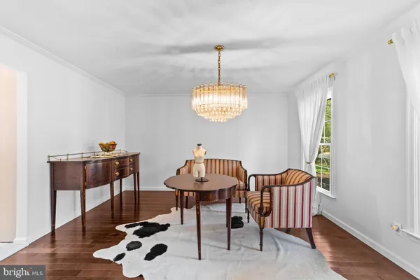 a view of a room with furniture and wooden floor