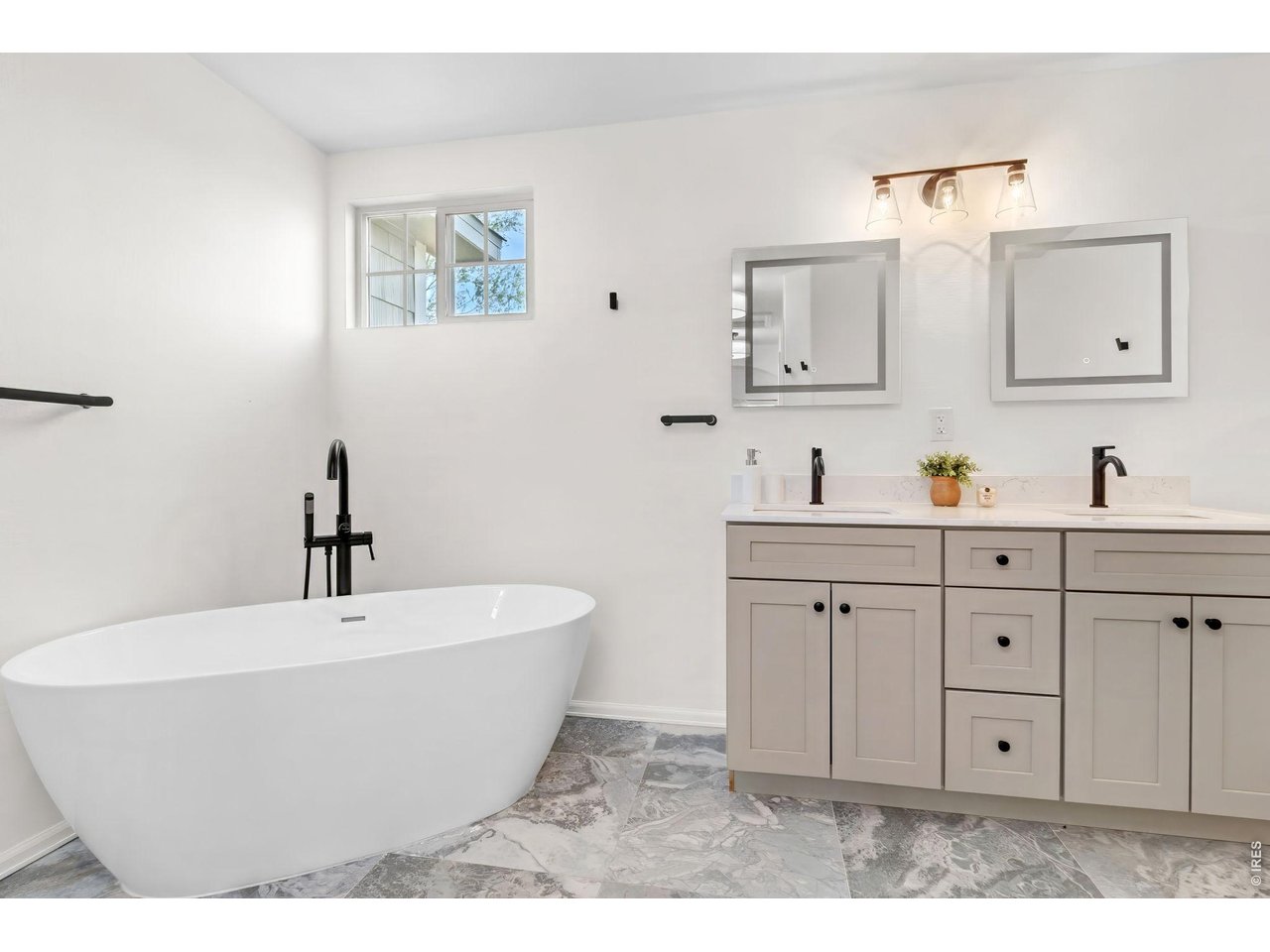 2521 Azalea Way Erie, CO 80516 - Photo 25 of 47 The primary ensuite 5-piece bathroom with soaking tub, double sink, and upgraded flooring, mirrors and lighting