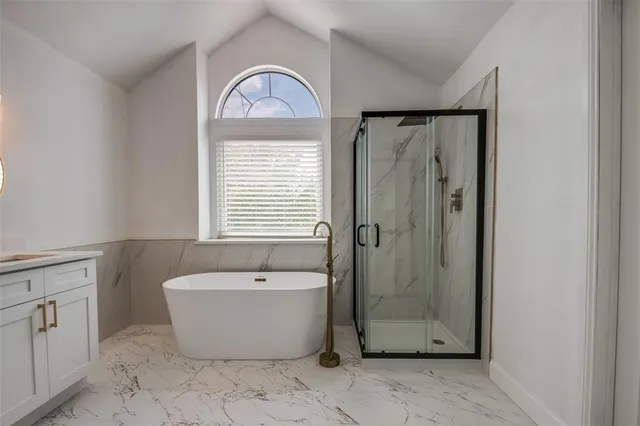 a bathroom with a bathtub and shower