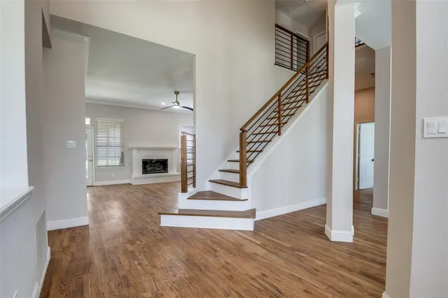 a view of entryway and hall with wooden floor