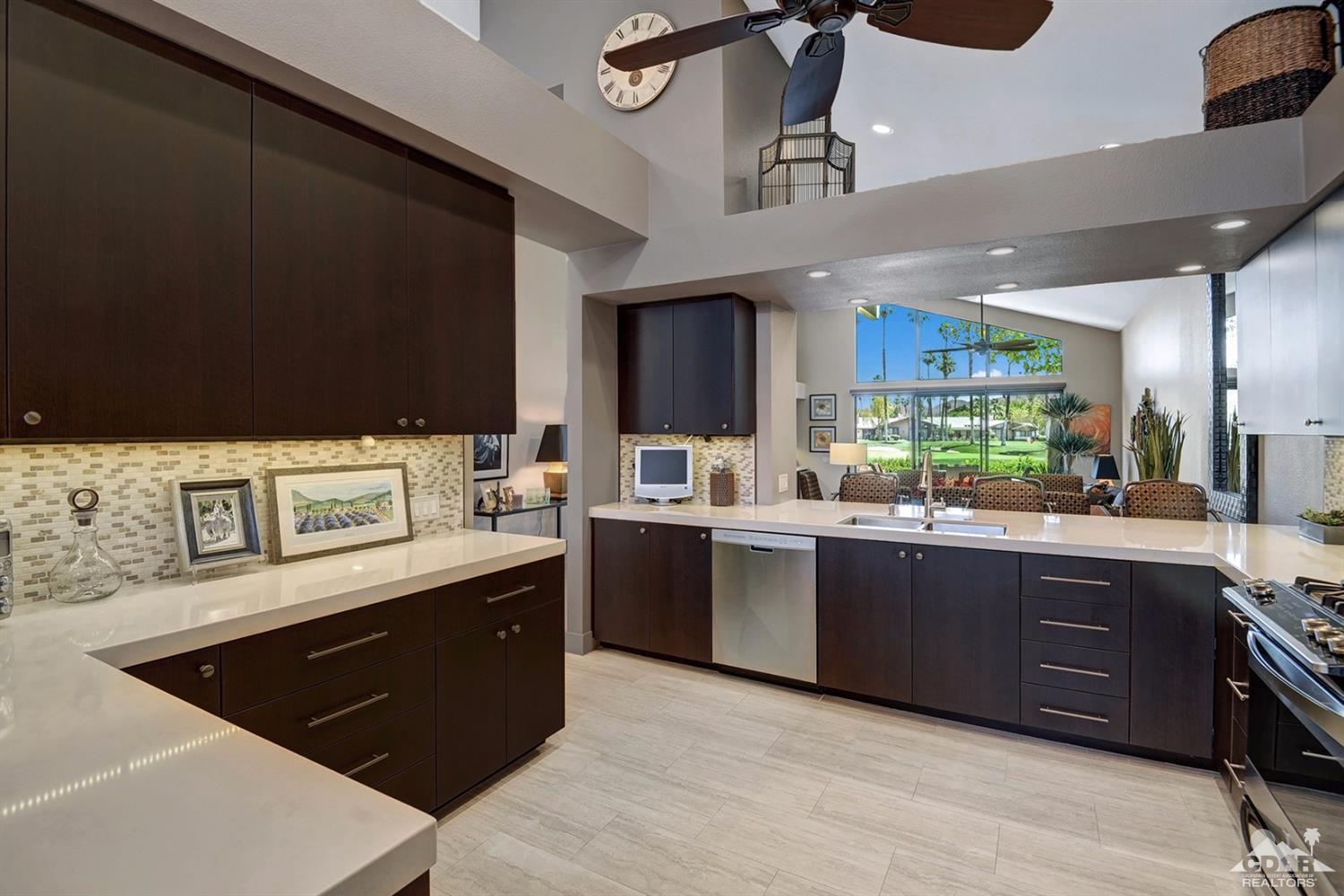 395 Red River Road Palm Desert, CA 92211 - Photo 13 of 29 a kitchen with stainless steel appliances kitchen island granite countertop a sink counter space and cabinets