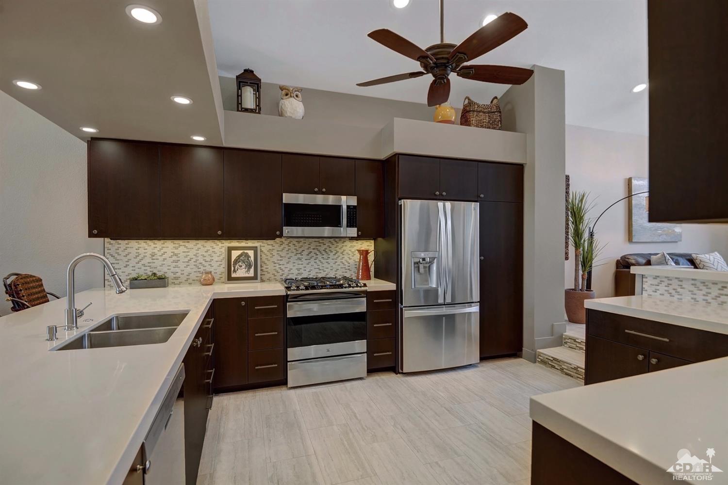 395 Red River Road Palm Desert, CA 92211 - Photo 14 of 29 a kitchen with stainless steel appliances a sink stove and refrigerator