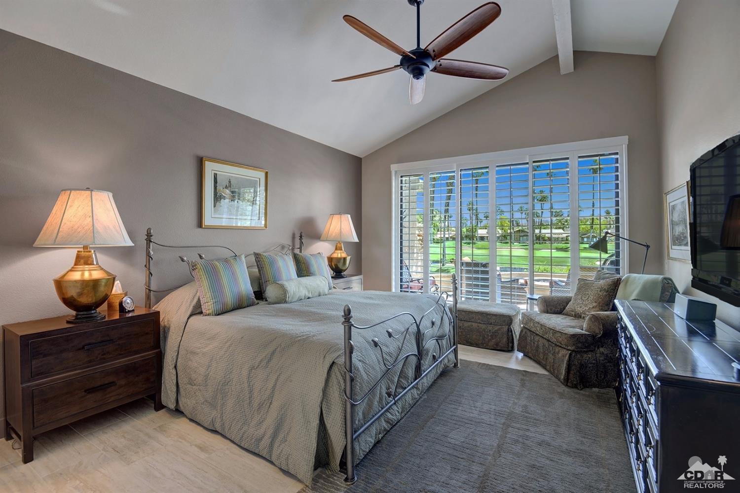 395 Red River Road Palm Desert, CA 92211 - Photo 15 of 29 a bedroom with a bed and a flat screen tv