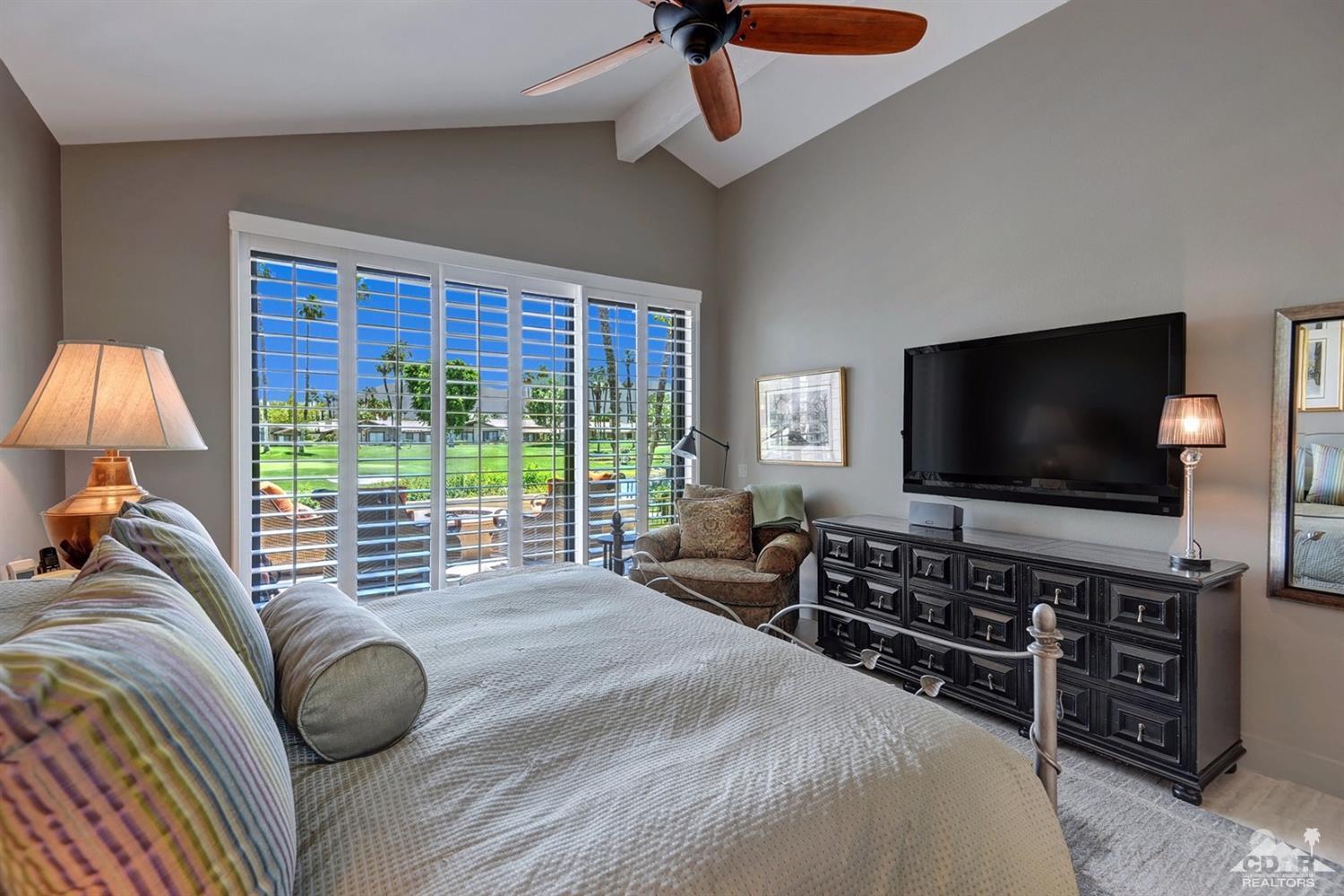 395 Red River Road Palm Desert, CA 92211 - Photo 16 of 29 a bedroom with a bed and a flat screen television