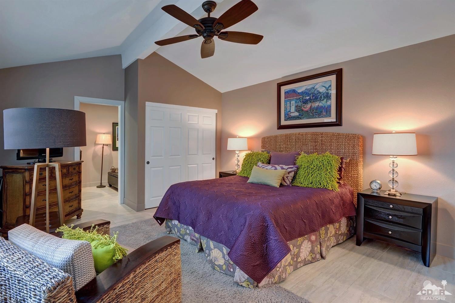 395 Red River Road Palm Desert, CA 92211 - Photo 19 of 29 a bedroom with a bed table and couch