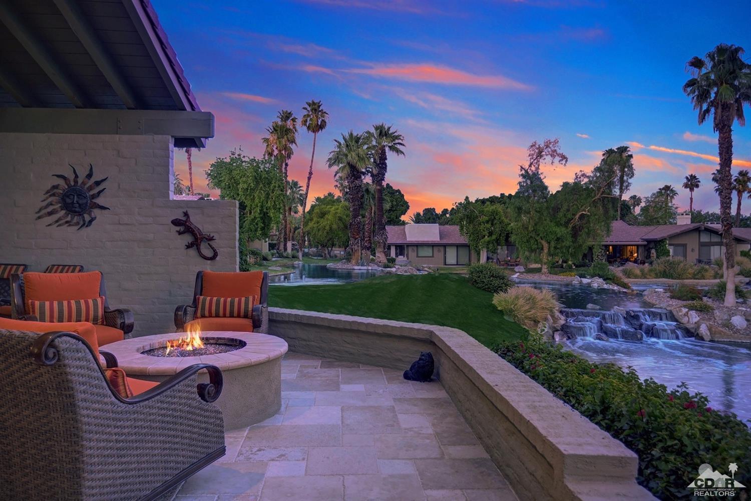 395 Red River Road Palm Desert, CA 92211 - Photo 2 of 29 a backyard of a house with table and chairs