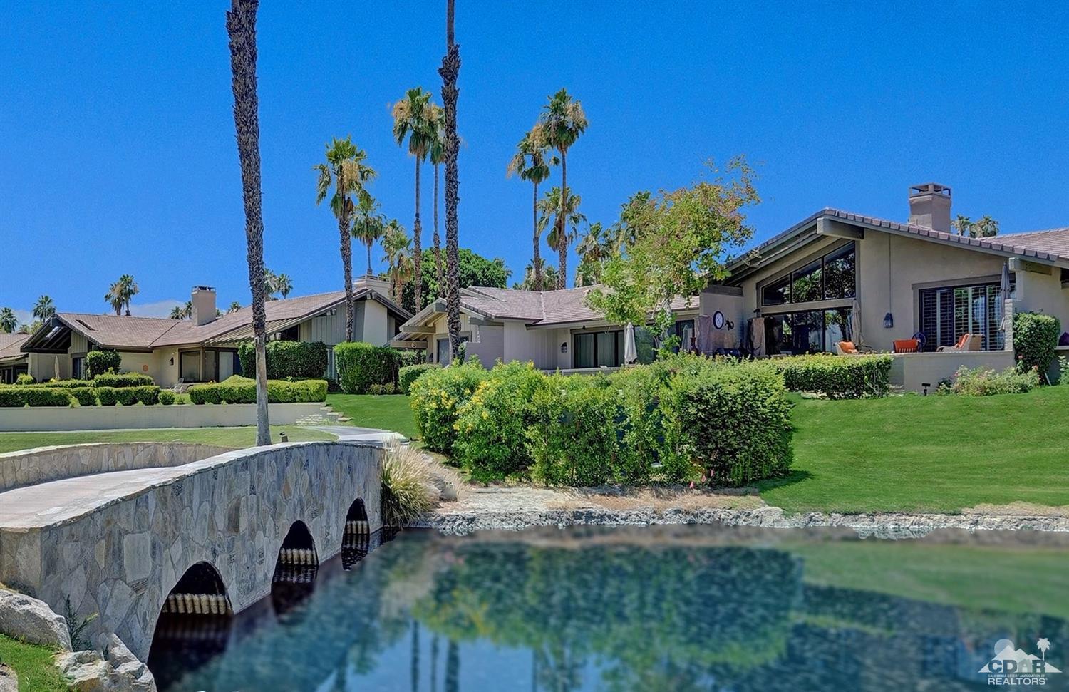 395 Red River Road Palm Desert, CA 92211 - Photo 27 of 29 a front view of a house with a yard and potted plants