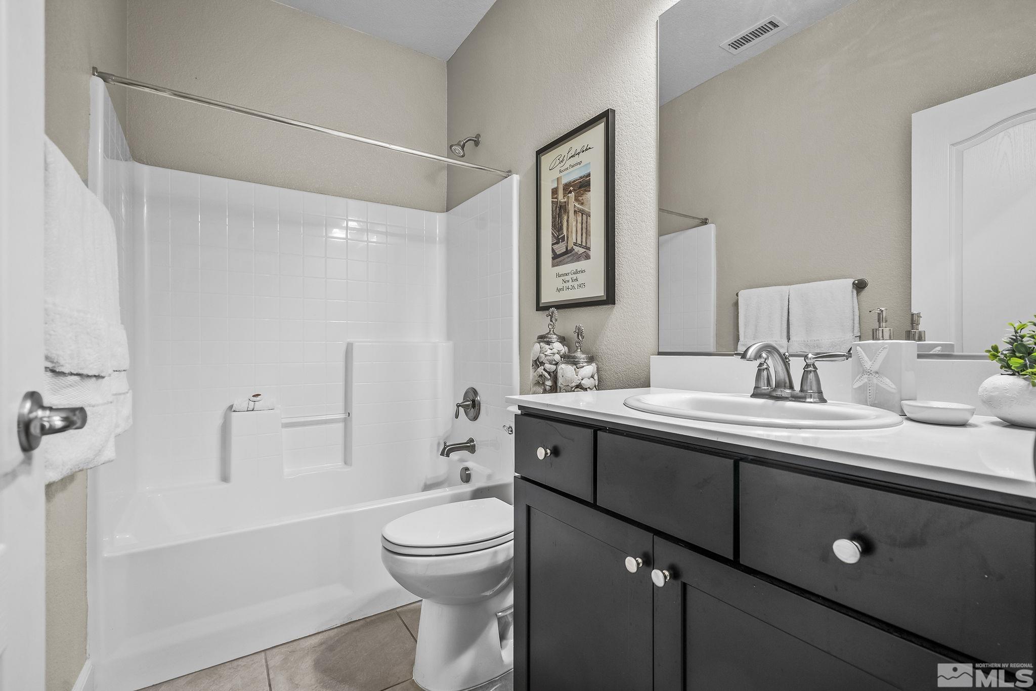 10325 Gold Mine Drive Reno, NV 89521 - Photo 15 of 38 a bathroom with a sink a toilet and shower