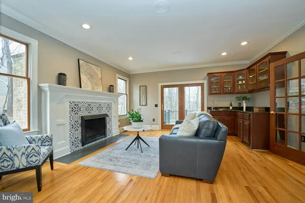 a view of a dining room and livingroom with furniture wooden floor a chandelier