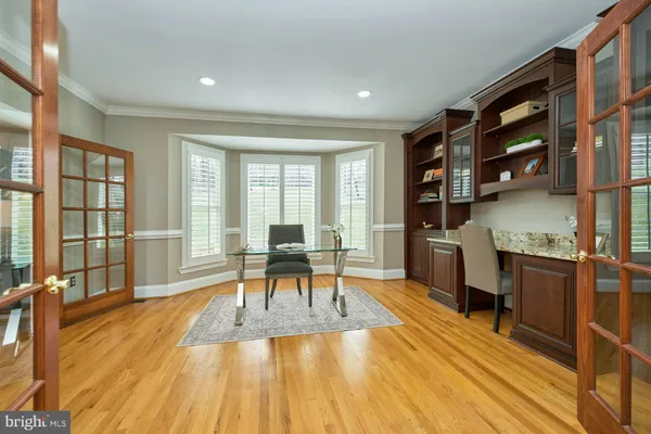 a dining room with furniture a chandelier and wooden floor
