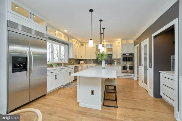 a view of a hallway with wooden floor and stairs