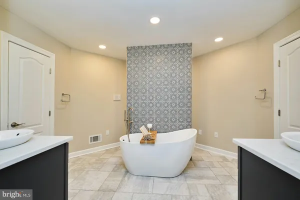 a aerial view of a house with swimming pool and large trees