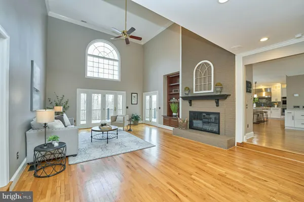a living room with furniture kitchen view and a large window