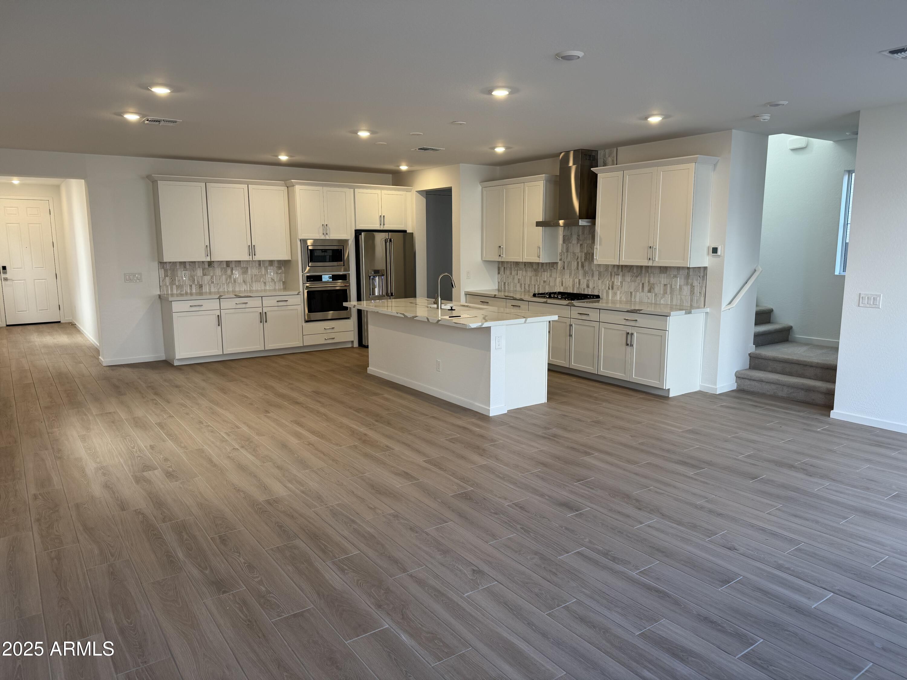 2458 West Maximo Way Phoenix, AZ 85085 - Photo 3 of 22 a large kitchen with stainless steel appliances granite countertop a large counter top a sink and a refrigerator