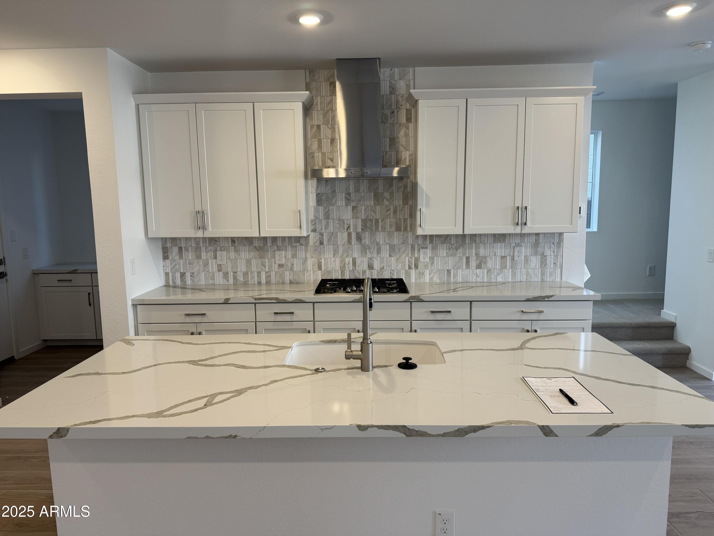 2458 West Maximo Way Phoenix, AZ 85085 - Photo 4 of 22 a kitchen with a sink and white cabinets