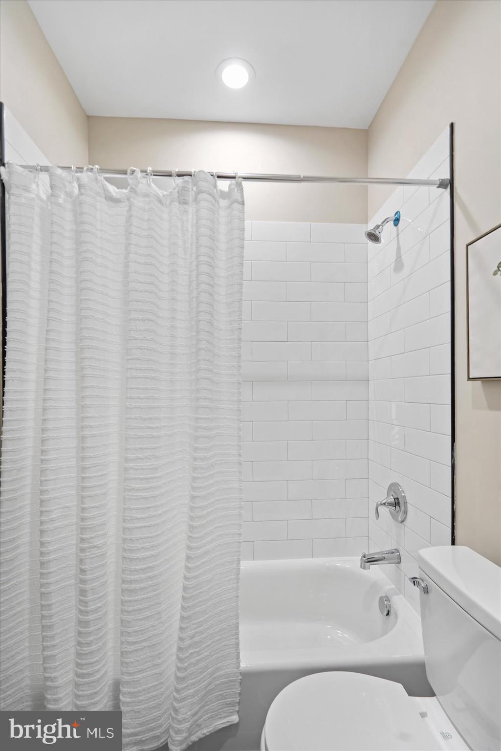 3919 Bonner Road Baltimore, MD 21216 - Photo 34 of 46 a bathroom with a shower curtain and a toilet