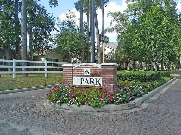 a view of a sign board with flower around