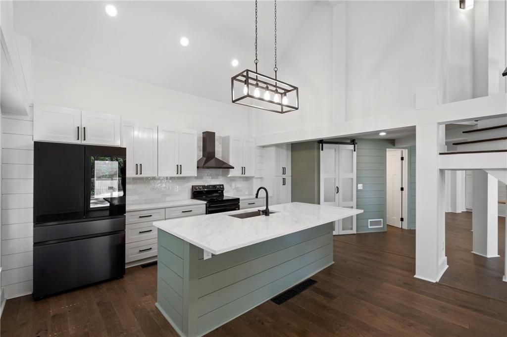 62 Bear Cub Ridge Big Canoe, GA 30143 - Photo 16 of 39 a kitchen with a sink stainless steel appliances and chandelier