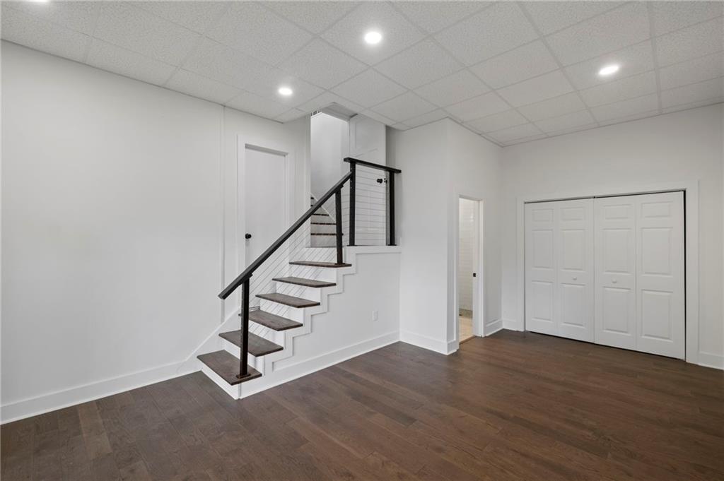 62 Bear Cub Ridge Big Canoe, GA 30143 - Photo 25 of 39 a view of an empty room with wooden floor and stairs