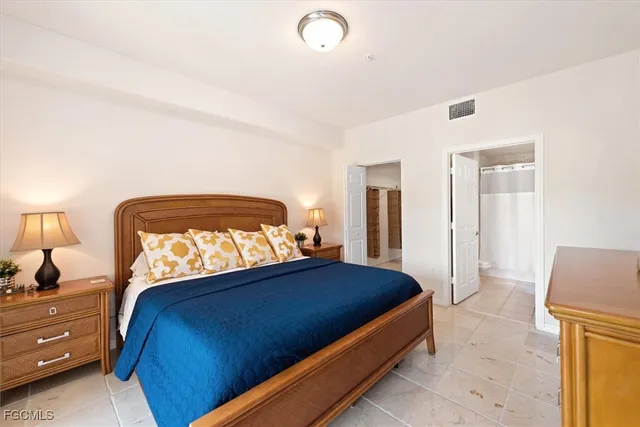 a bedroom with a bed and a mirror on dresser