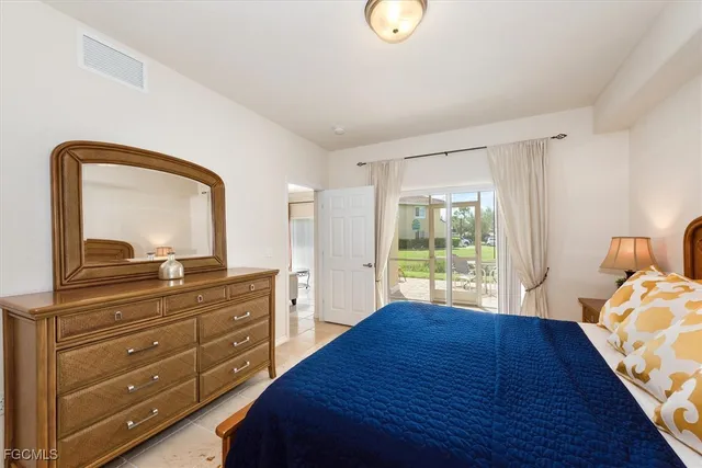 a bathroom with a granite countertop double vanity sink and a mirror