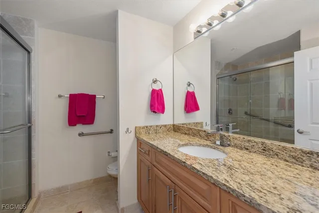 a bathroom with a glass shower door